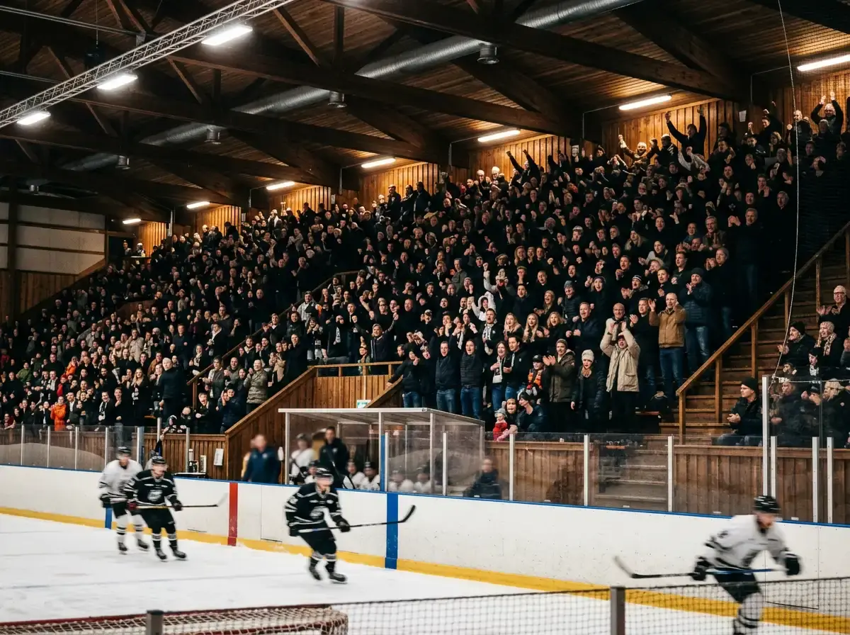Fyldt dansk ishockeyarena med tilskuere på tribunerne under klubkamp